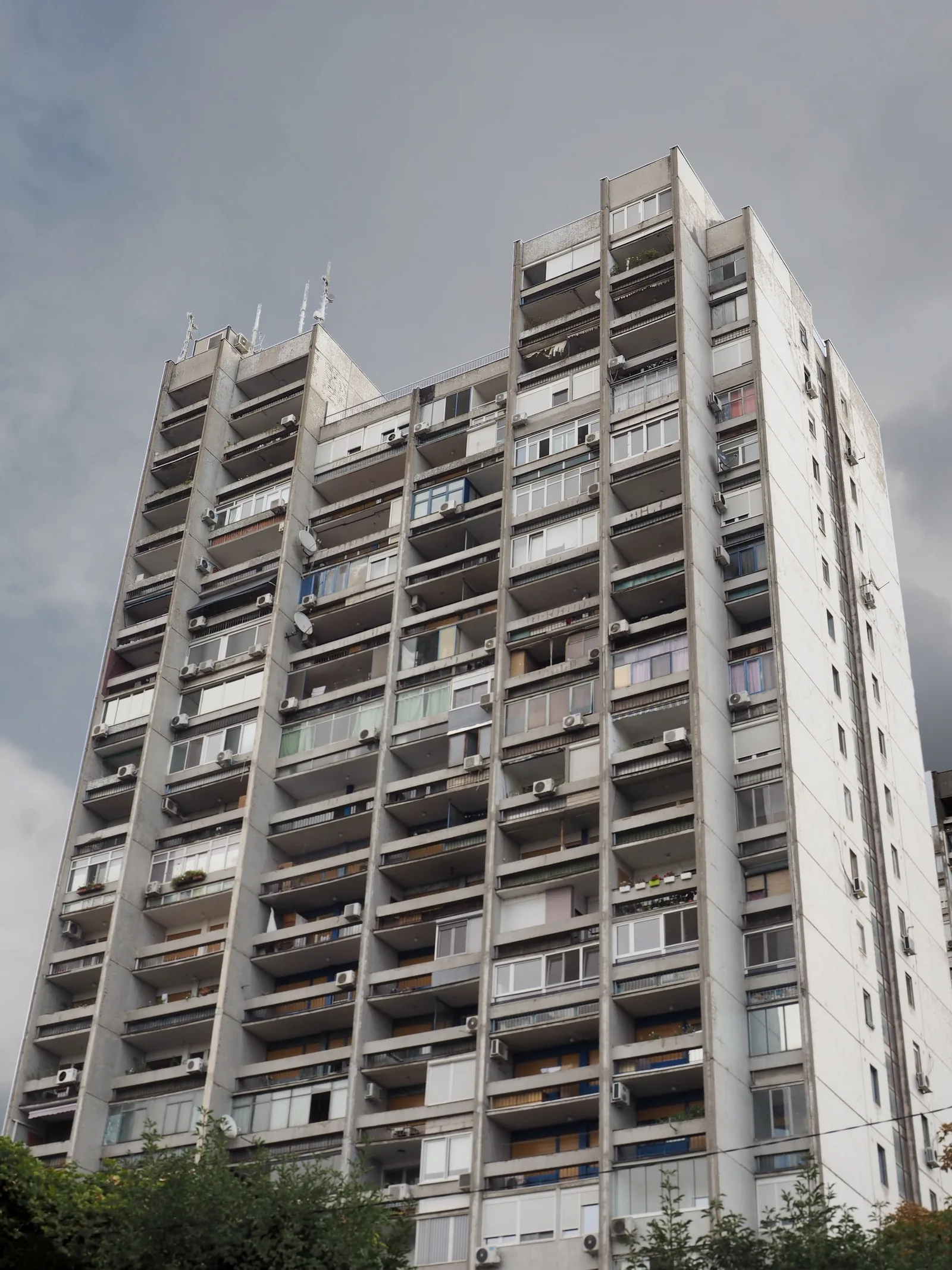 A tall apartment block with many balconies