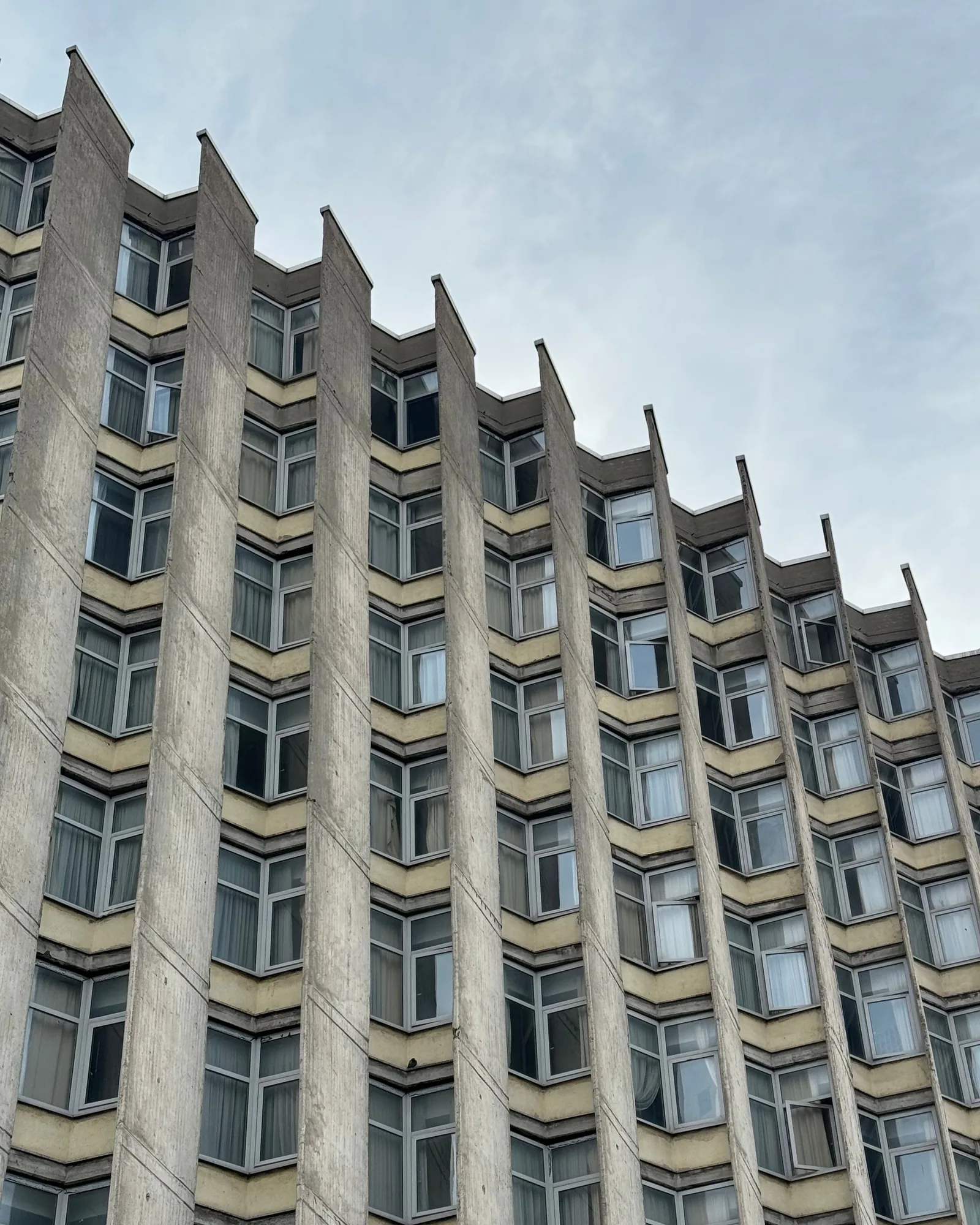 A facade with angled window bays