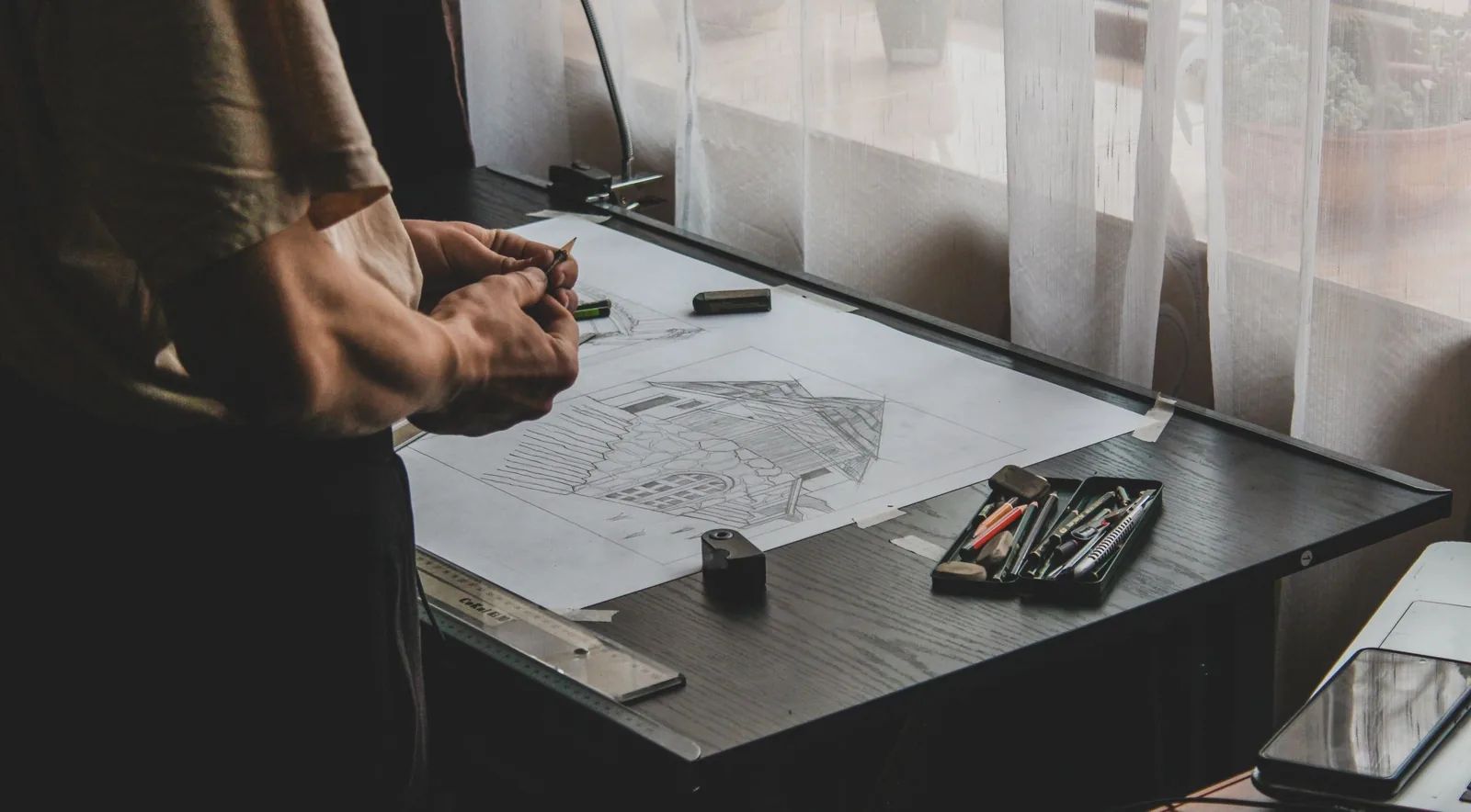 Drawing tools and plans on a desk